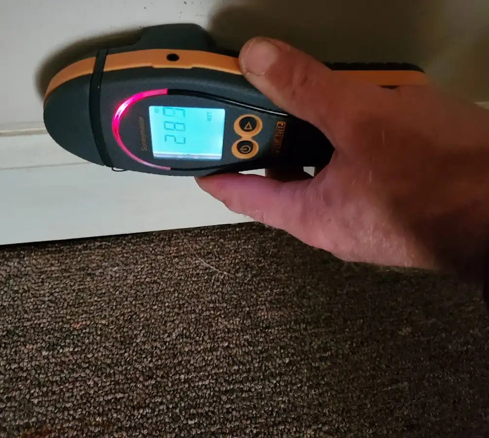 Moisture detection at baseboard during Storm Damage Restoration in Pontotoc